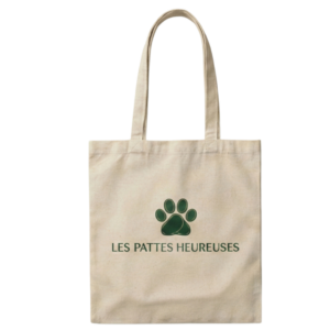 Sac en toile beige avec une empreinte de patte verte et le texte Les Pattes Heureuses.